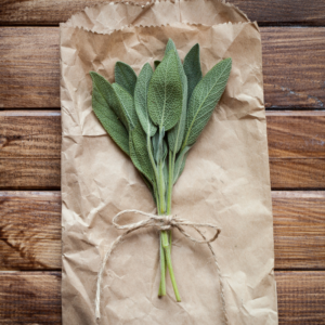 White sage leaves top view on a brown bag wooden table