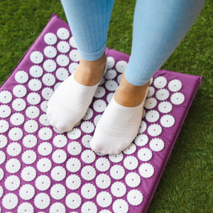 top view woman standing on acupressure mat