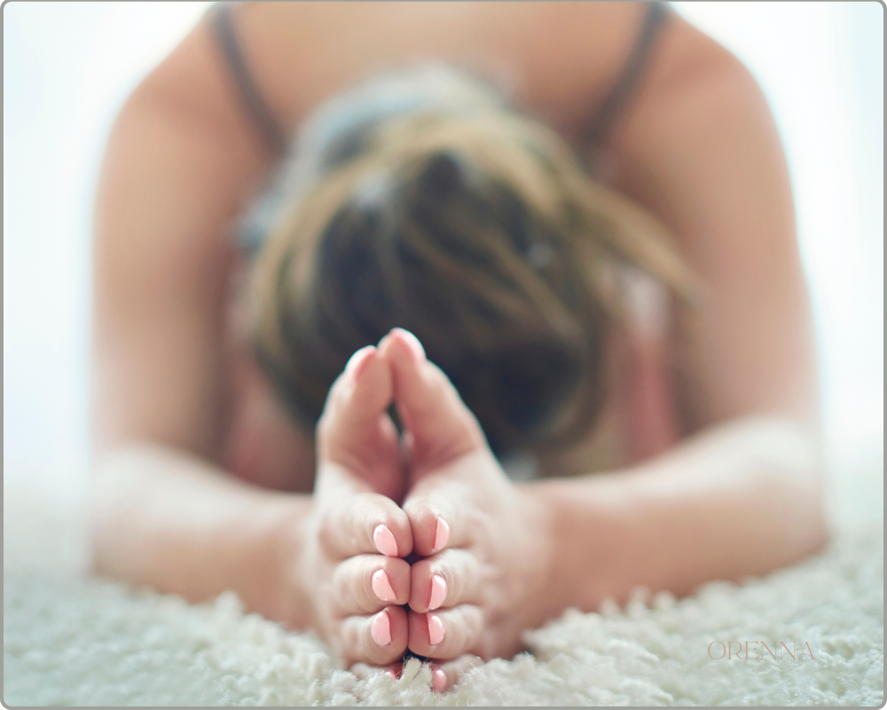 About orenna woman practicing yoga on a carpet