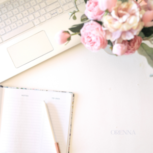 Modern journaling with a notebook, flowers and a laptop