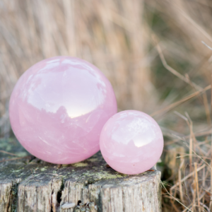 Rose quarts crystals spheres on a log