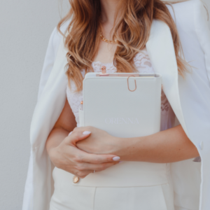 about orenna professional woman holding a journal