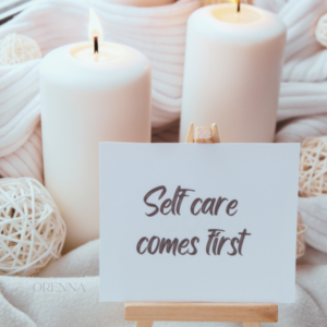 self care come first sign in front of two white candles