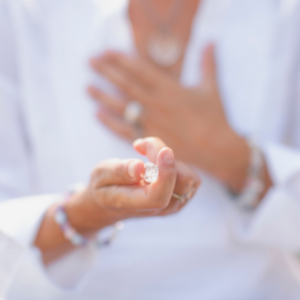 woman holding a white quartz crystal